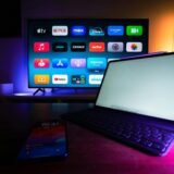 A modern home setup with a smart TV and tablet displaying various streaming apps, highlighting the digital lifestyle.